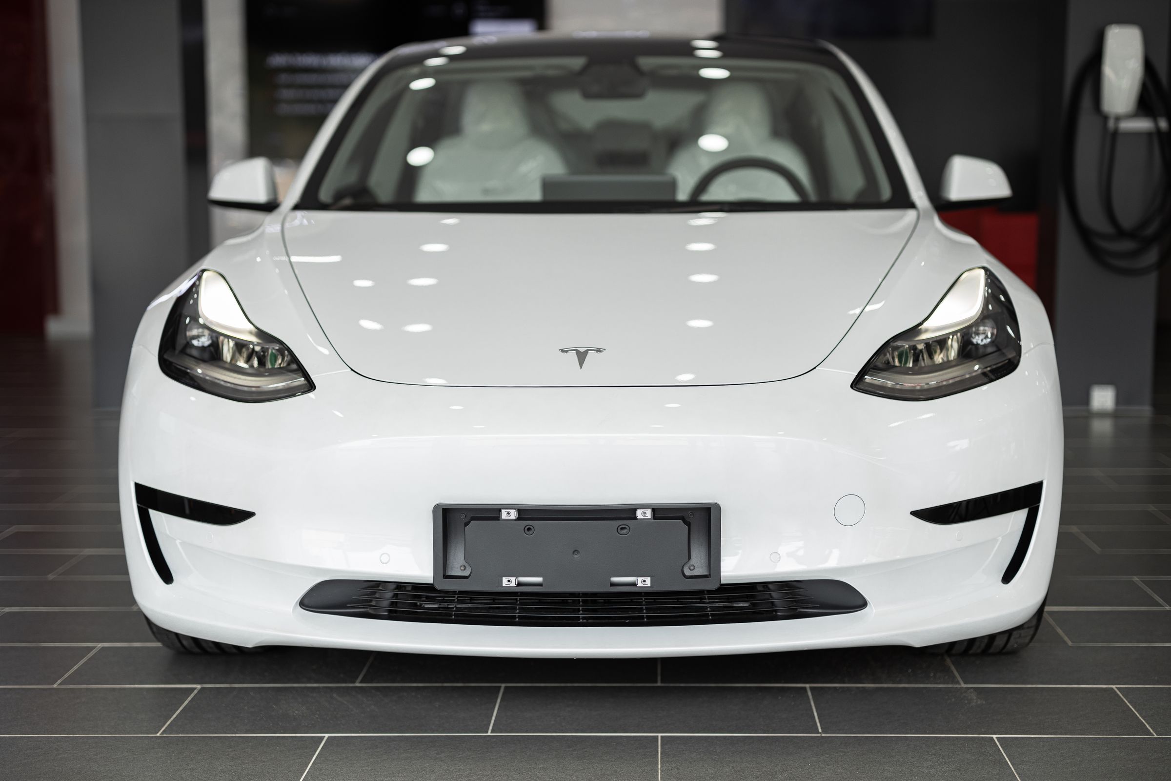 White electric vehicle shown as a condition-inspection visual example